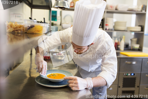 Image of happy male chef cooking food at restaurant kitchen