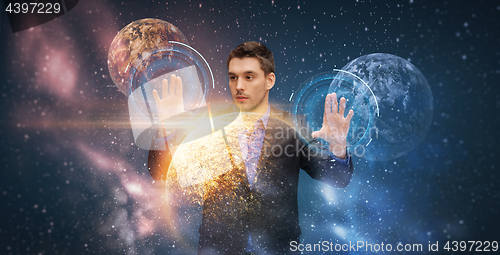 Image of businessman with virtual planets and space