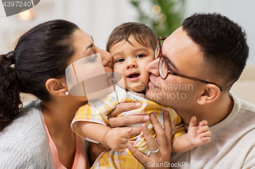 Image of happy mother and father kissing baby daughter