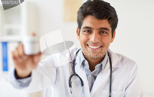 Image of happy doctor with stethoscope and medication