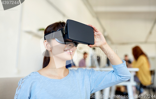 Image of happy woman with virtual reality headset at office