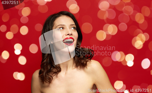 Image of beautiful smiling young woman with red lipstick