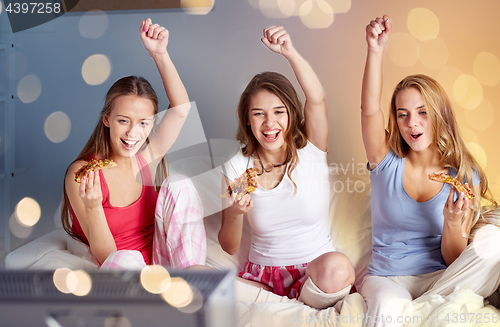 Image of happy friends or teen girls eating pizza at home