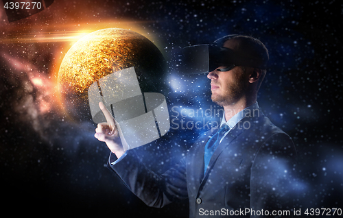 Image of businessman in virtual reality headset over space