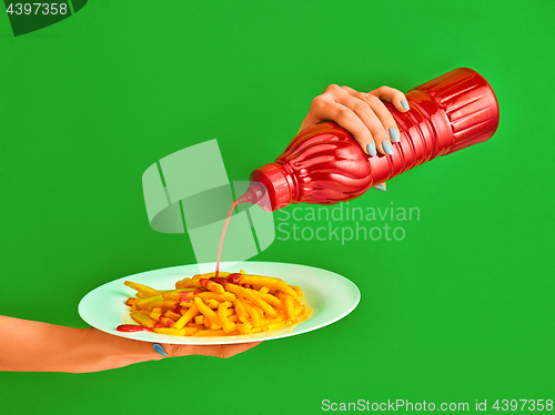 Image of Young woman with plate of french fries potato with ketchup