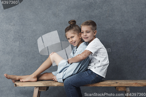 Image of A portrait of little girl and a boy on the gray background