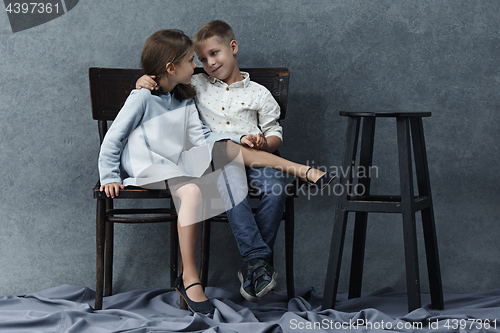 Image of A portrait of little girl and a boy on the gray background