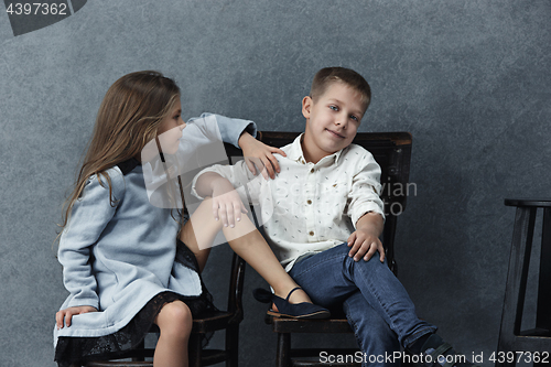 Image of A portrait of little girl and a boy on the gray background