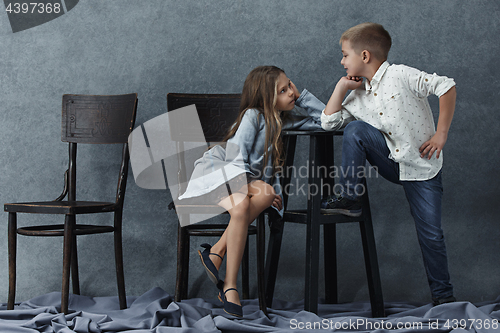 Image of A portrait of little girl and a boy on the gray background