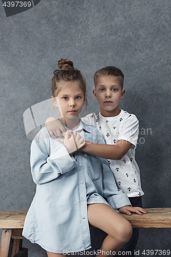 Image of A portrait of little girl and a boy on the gray background