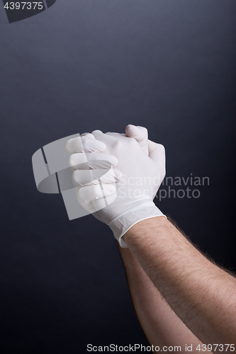 Image of Male hands in latex gloves