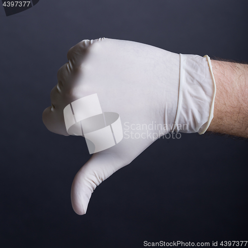 Image of Male hand in latex glove