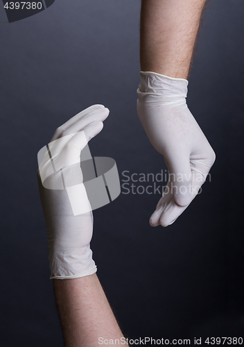 Image of Male hands in latex gloves