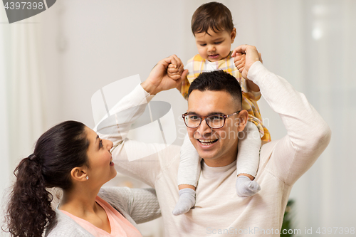 Image of happy family and baby daughter playing at home