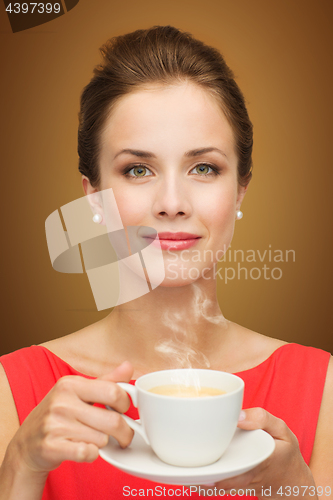 Image of beautiful woman in red dress with cup of coffee
