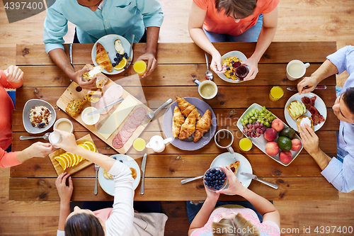 Image of group of people having breakfast at table