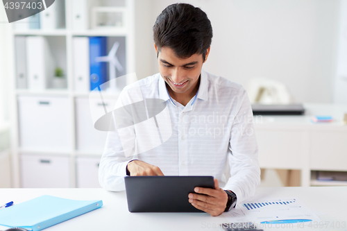 Image of businessman working with tablet pc at office