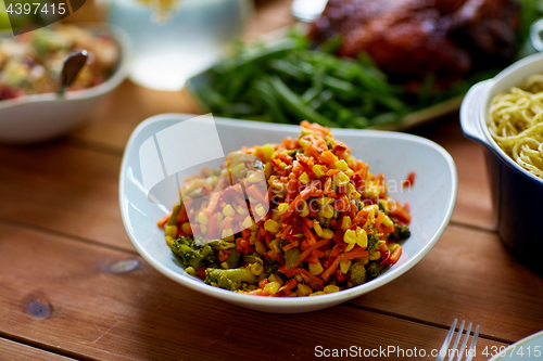 Image of vegetable salad in bowl on wooden table