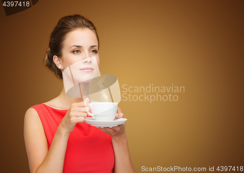 Image of beautiful woman in red dress with cup of coffee