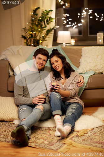 Image of happy couple drinking coffee and eating at home