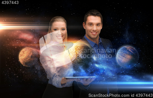 Image of businesspeople with tablet pc and planets in space