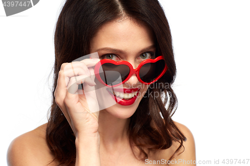 Image of woman with red lipstick and heart shaped shades