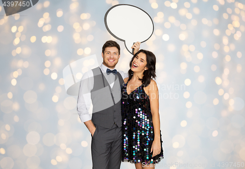 Image of happy couple at party holding text bubble banner