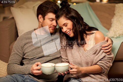 Image of happy couple drinking cacao at home