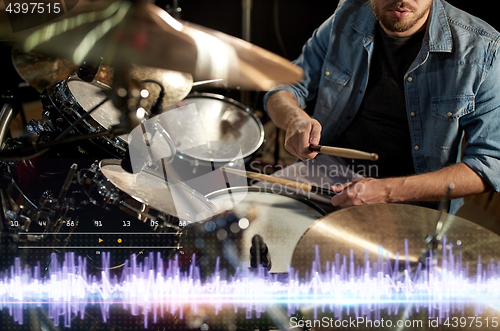 Image of drummer playing drum kit at sound recording studio