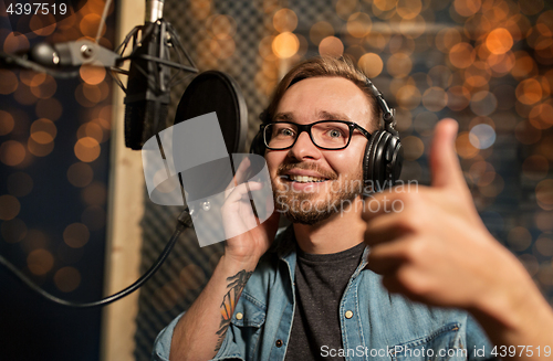 Image of man with headphones at music recording studio