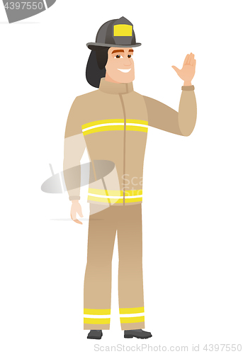 Image of Young caucasian firefighter waving his hand.
