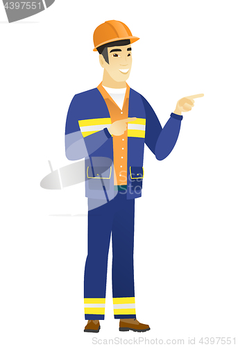 Image of Young asian builder pointing to the side.