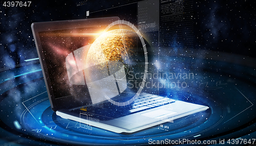 Image of laptop with virtual planet and space hologram