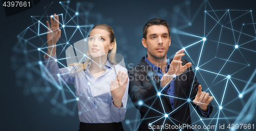 Image of businessman and businesswoman with virtual network