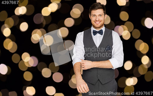 Image of happy man in festive suit dressing for party