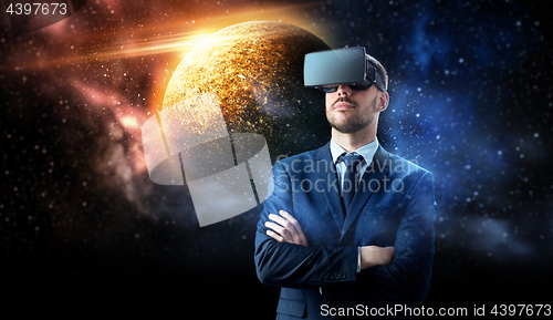 Image of businessman in virtual reality headset over space