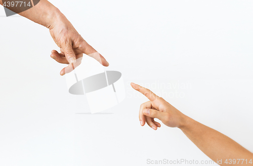 Image of close up of senior and young woman hands