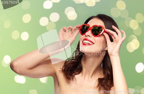 Image of woman with red lipstick and heart shaped shades