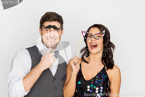 Image of happy couple with party props having fun