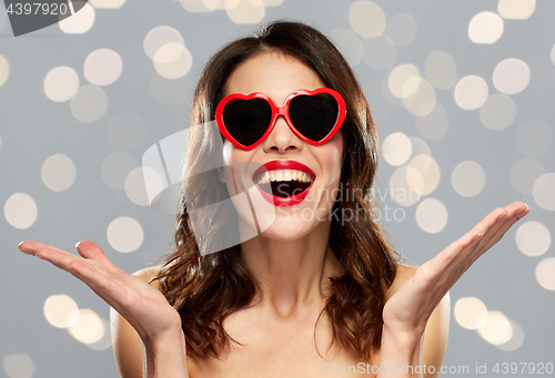 Image of woman with red lipstick and heart shaped shades