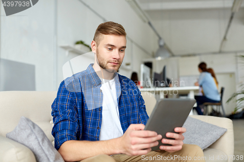 Image of man with tablet pc working at office