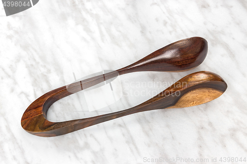 Image of Wooden musical spoons on marble background