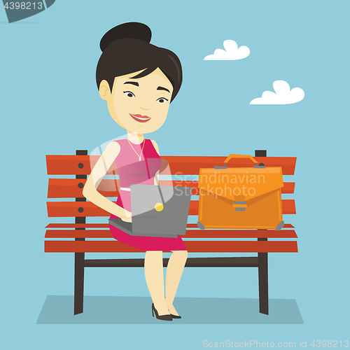 Image of Business woman working on laptop outdoor.
