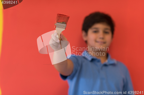 Image of Portrait of a happy young boy painter