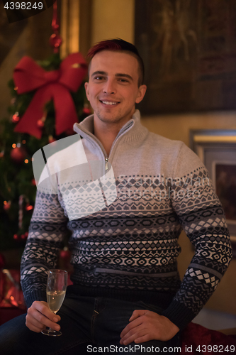 Image of Happy young man with a glass of champagne