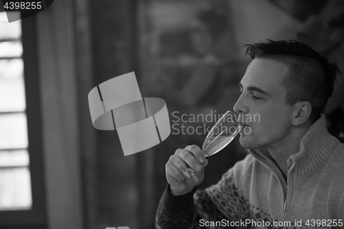 Image of Happy young man with a glass of champagne