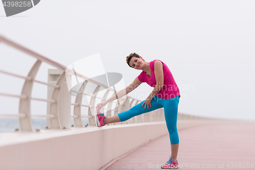 Image of woman stretching and warming up on the promenade