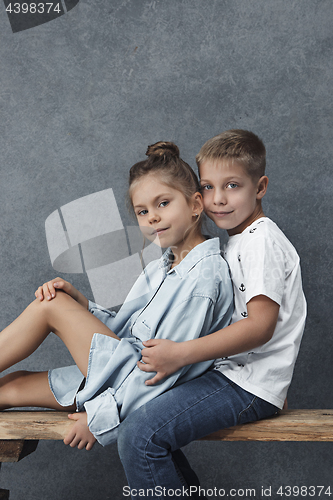 Image of A portrait of little girl and a boy on the gray background