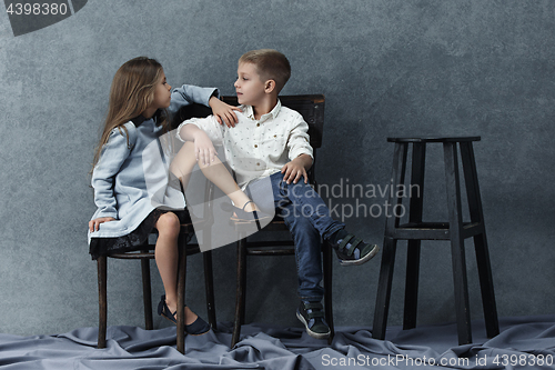 Image of A portrait of little girl and a boy on the gray background