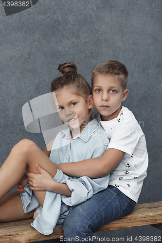 Image of A portrait of little girl and a boy on the gray background